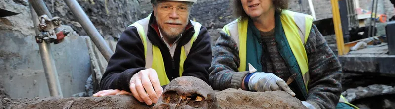 Archaeologist digging up skeleton of Scottish soldiers