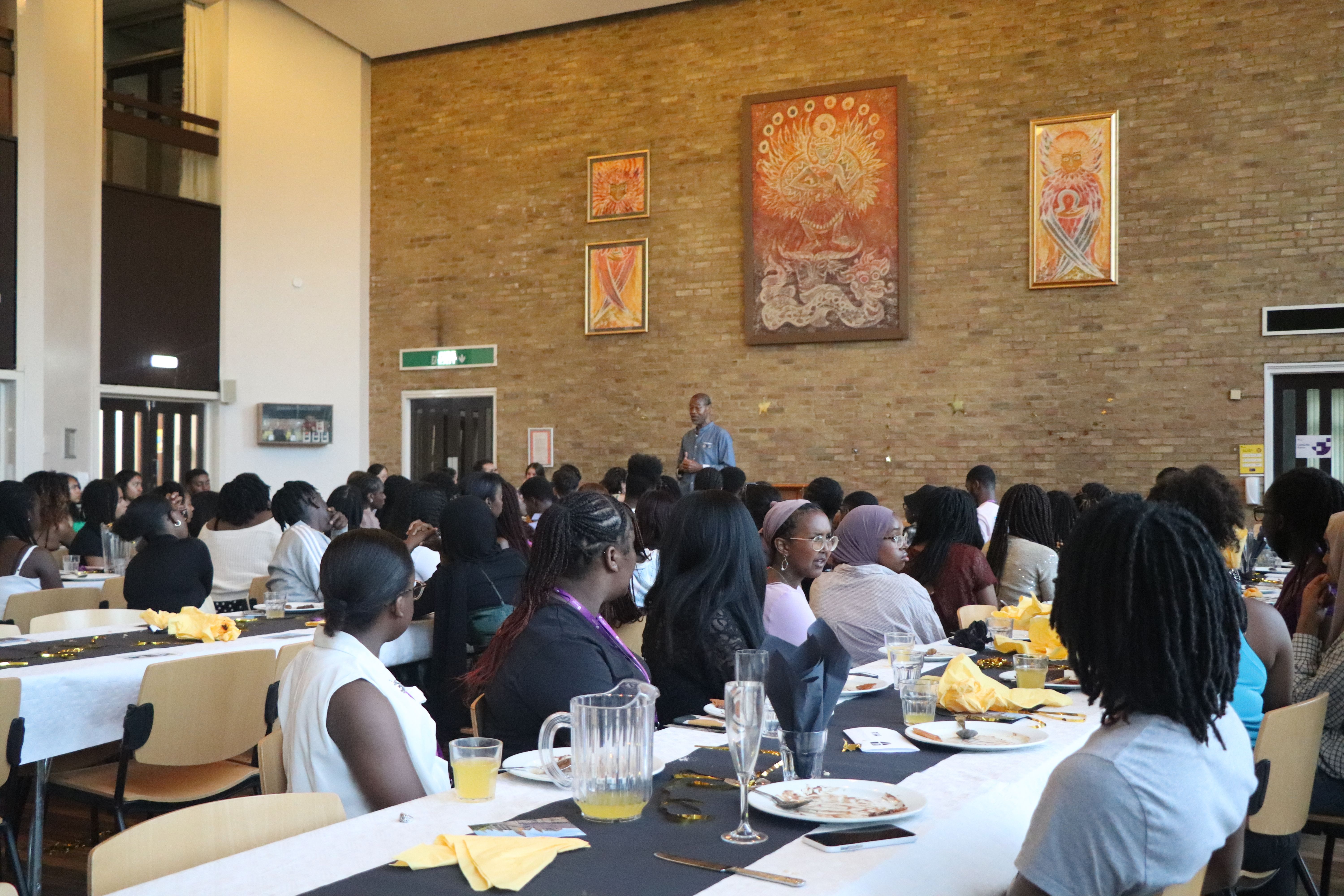 The STEP cohort at a formal dinner listening to the keynote speaker.